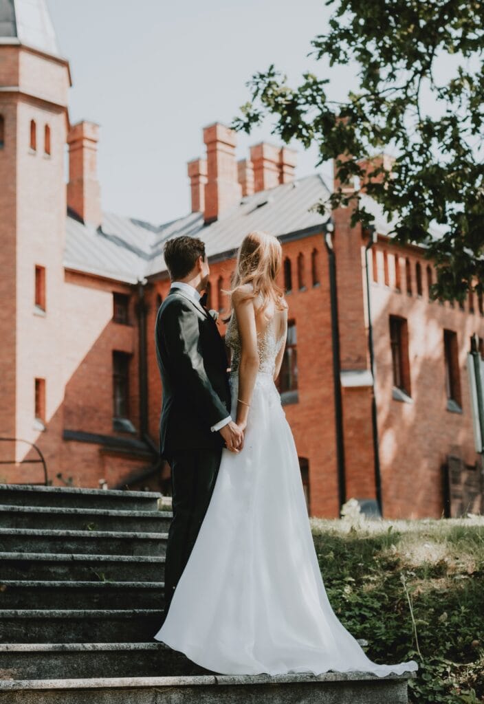 Pildil on pruutpaar vaatamas Sangaste lossi poole