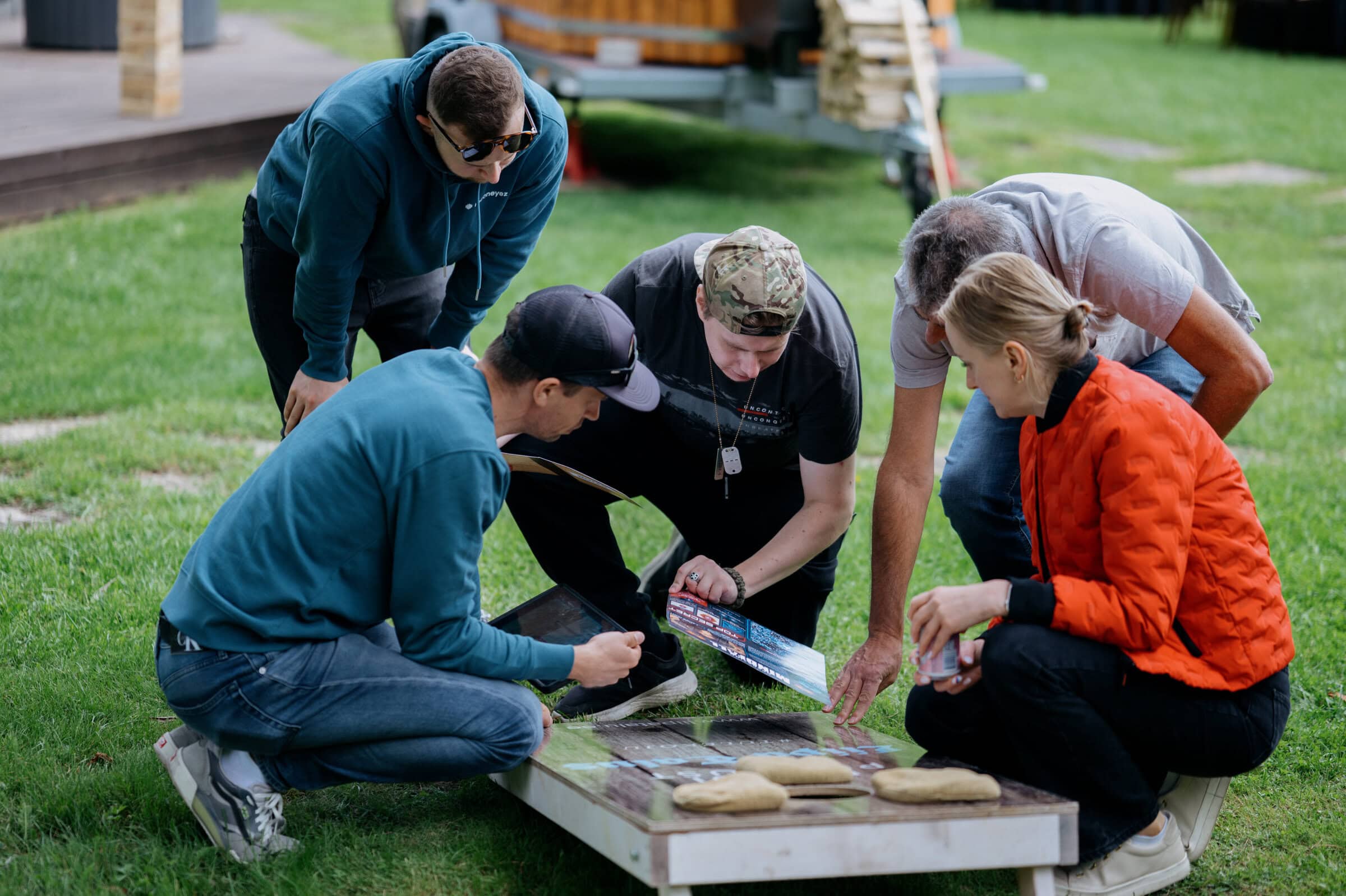 Team events planning Five employees brainstorming together on a task during summer days