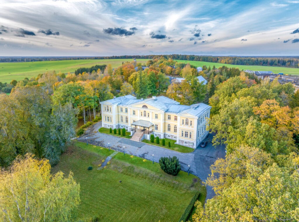 Aerial view of Kuremaa Castle, surrounded by lush greenery.