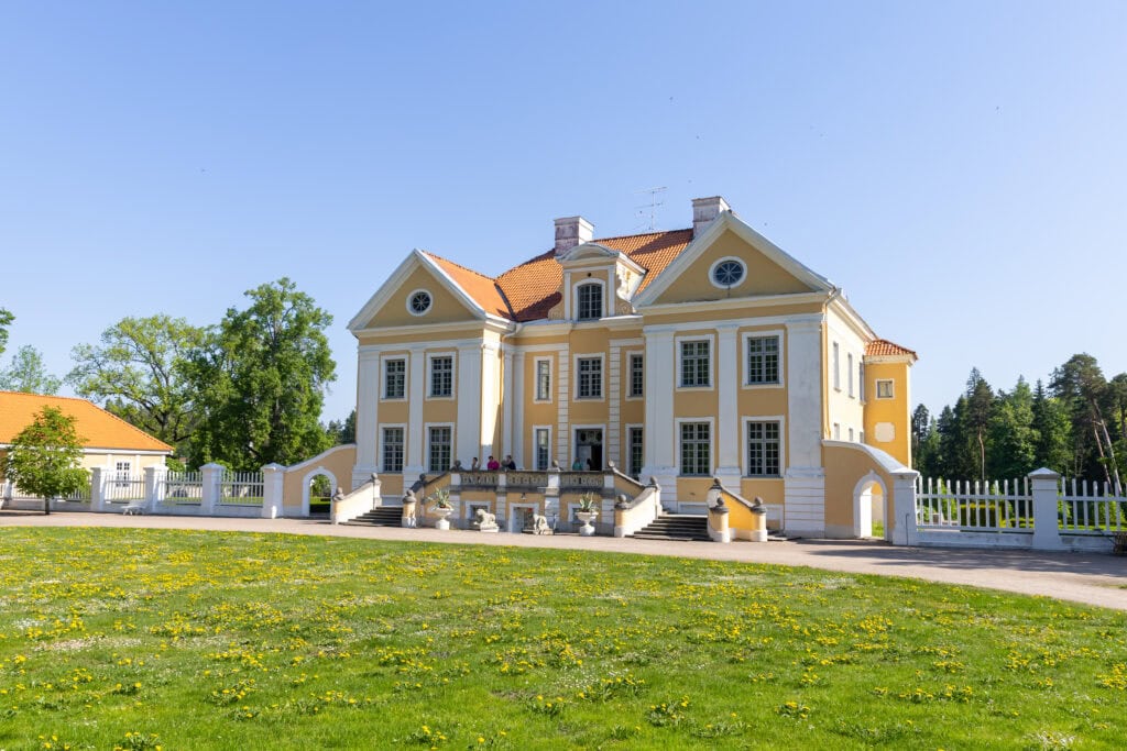 Palmse Manor from the front, glowing in the sunlight.