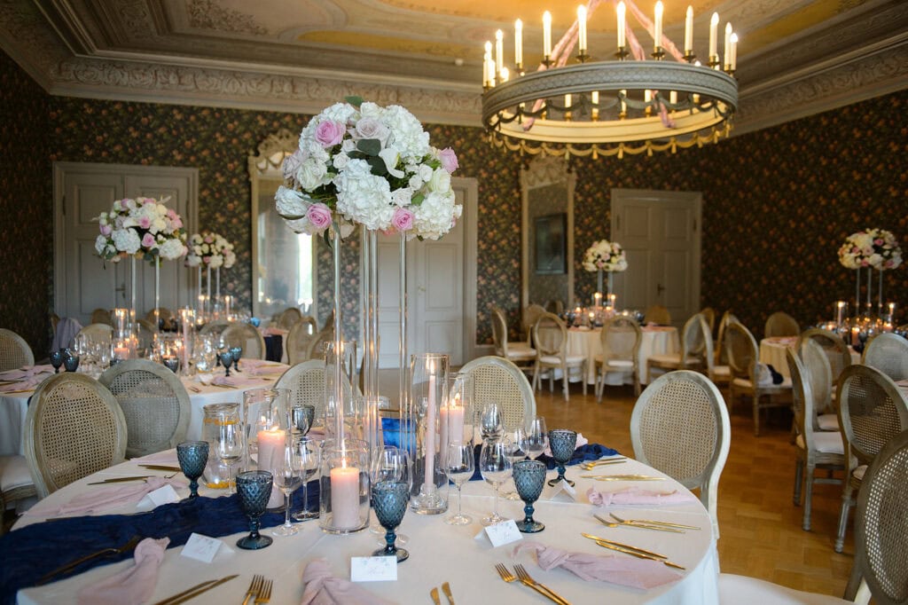 The event hall at Sagadi Manor, beautifully styled by Celebrate Group using dark blue and pink tones.
