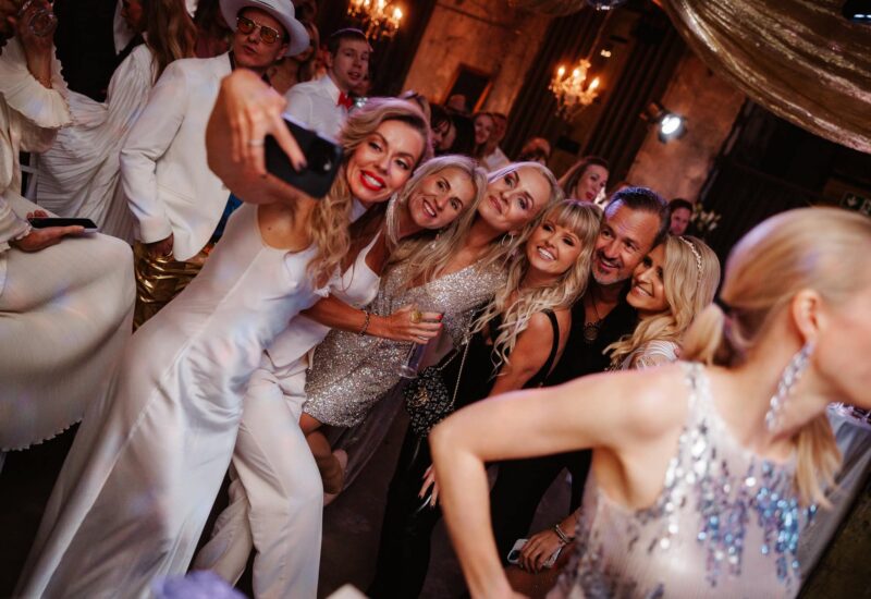 Elegant event with guests exchanging drinks at Celebrate Group party.
